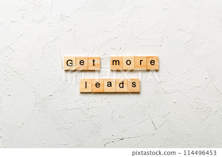 Get more leads word written on wood block. Get more leads text on table, concept 114496453