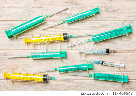 Top view of many syringes prepared for injection at wooden background. Treatment concept with copy space 114496548
