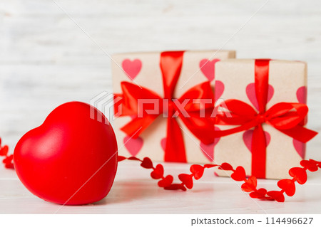 gift box with red bow and red heart on colored background. Perspective view. Flat lay 114496627