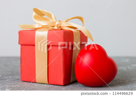 gift box with red bow and red heart on colored background. Perspective view. Flat lay 114496629