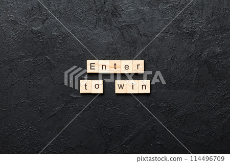 Enter To Win word written on wood block. Enter To Win text on cement table for your desing, concept Enter To Win word written on wood block. Enter To Win text on cement table for your desing, concept 114496709