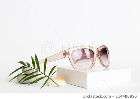 sunglasses with seashell lying on table background. Sunglasses on summer background. Top view flat lay with copy space for text sunglasses with seashell lying on table background. Sunglasses on summer background. Top view flat lay with copy space for text 114496950