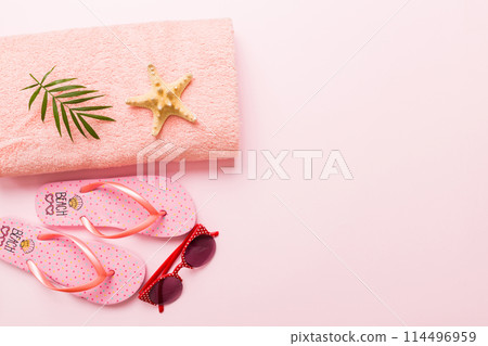 Summer sunbathing beach background, sunglasses, flip flops and towel, Top view with copy space for text 114496959