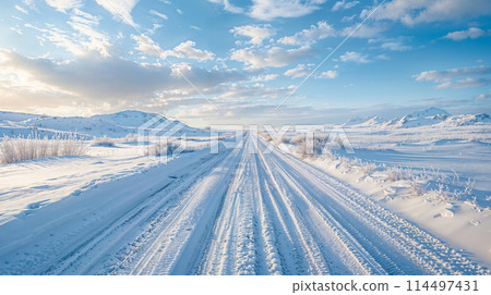 Winter wonderland: snow-covered road under blue skies Winter wonderland: snow-covered road under blue skies 114497431