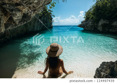 Serene tropical escape: woman at paradise cove 114497439
