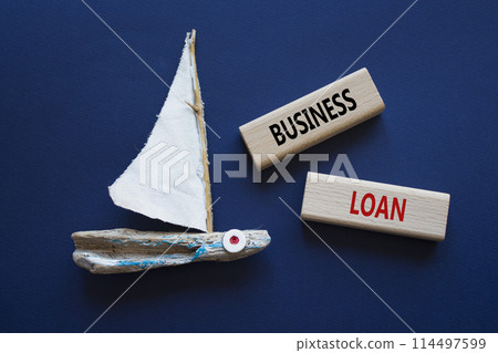 Business loan symbol. Concept words business loan on wooden blocks. Beautiful deep blue background with boat. Business and business loan concept. Copy space. 114497599