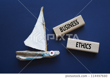Business ethics symbol. Concept word Business ethics on wooden blocks. Beautiful deep blue background with boat. Business and Business ethics concept. Copy space Business ethics symbol. Concept word Business ethics on wooden blocks. Beautiful deep blue background with boat. Business and Business ethics concept. Copy space 114497680