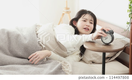A woman who stops the alarm clock A woman who stops the alarm clock 114497808
