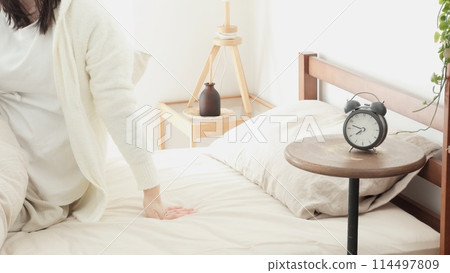 woman getting out of bed in the morning woman getting out of bed in the morning 114497809