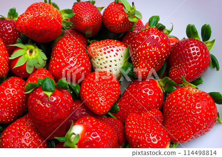Strawberries. Red large ripe strawberries close-up. Harvest berries. Red strawberries background. Food background. Strawberries. Red large ripe strawberries close-up. Harvest berries. Red strawberries background. Food background. 114498814