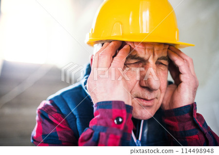 Older worker feeling strong headache. Stroke symptoms. Migraine as severe headache with throbbing pain. 114498948