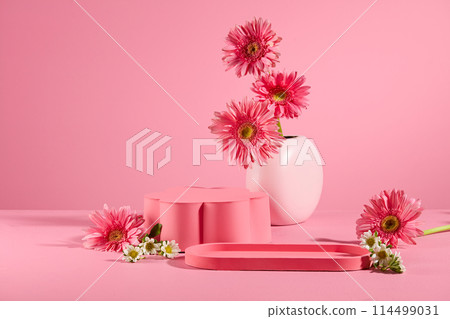 Photo for advertise products derived from flowers with an empty podium and tray placed on table over pink background, decorated by gerbera daisy flower. Copy space, front view Photo for advertise products derived from flowers with an empty podium and tray placed on table over pink background, decorated by gerbera daisy flower. Copy space, front view 114499031
