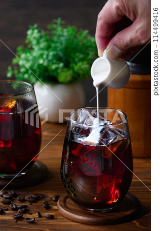 Pour fresh into iced coffee Pour fresh into iced coffee 114499416