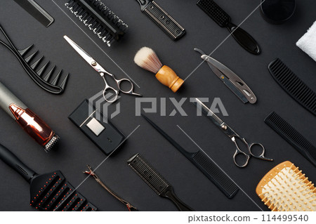 Variety of Hair Styling Tools and Accessories Displayed on a Dark Background Variety of Hair Styling Tools and Accessories Displayed on a Dark Background 114499540