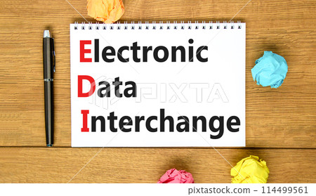 EDI electronic data interchange symbol. Concept words EDI electronic data interchange on white note. Beautiful wooden table background. Business and EDI electronic data interchange concept. Copy space EDI electronic data interchange symbol. Concept words EDI electronic data interchange on white note. Beautiful wooden table background. Business and EDI electronic data interchange concept. Copy space 114499561