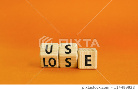 You use or lose it symbol. Concept word Use or lose on wooden cubes. Beautiful orange table orange background. Business and you use or lose it concept. Copy space. 114499928