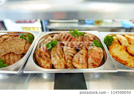 Grilled Chicken Breasts and Pork Cutlets Served in a Buffet Setting Grilled Chicken Breasts and Pork Cutlets Served in a Buffet Setting 114500050