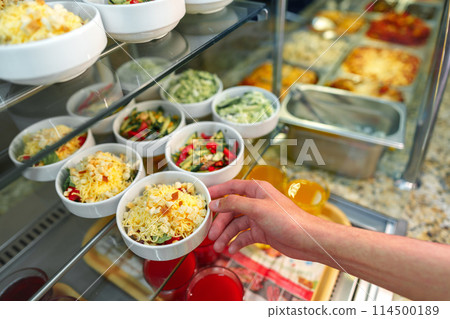 Person Reaching for Cup of Food Person Reaching for Cup of Food 114500189