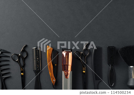 An Assortment of Professional Hairdressing Tools Laid Out on a Dark Surface An Assortment of Professional Hairdressing Tools Laid Out on a Dark Surface 114500234