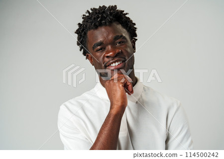 African Man in White Shirt Posing for a Picture in Studio. African Man in White Shirt Posing for a Picture in Studio. 114500242