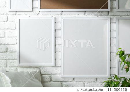 Varied Sized Photo Frames Displayed on a White Brick Wall Varied Sized Photo Frames Displayed on a White Brick Wall 114500356