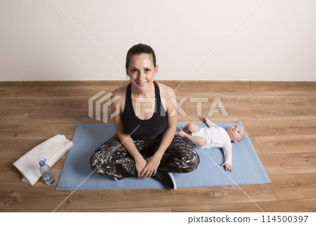 Home exercise for mother and baby, mommy and me workout. Physical activity for mother while bonding with children. 114500397