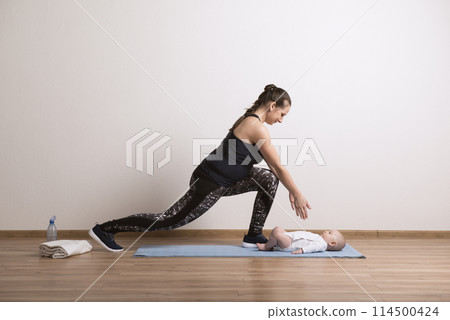 Home pilates exercise for mother and baby, mommy and me workout. Physical activity for mother while bonding with children. Home pilates exercise for mother and baby, mommy and me workout. Physical activity for mother while bonding with children. 114500424
