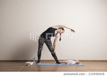 Home exercise for mother and baby, mommy and me workout. Physical activity for mother while bonding with children. Home exercise for mother and baby, mommy and me workout. Physical activity for mother while bonding with children. 114500426