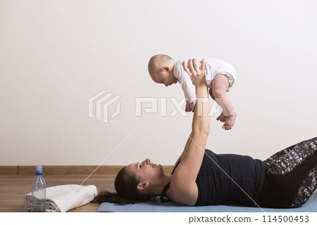 Home exercise for mother and baby, mommy and me workout. Using the baby's weight while lifting. 114500453