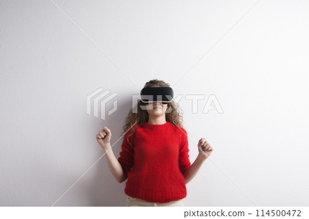 Young teenage girl with VR headset. Virutal reality, VR technology. Studio shot on white background with copy space. 114500472