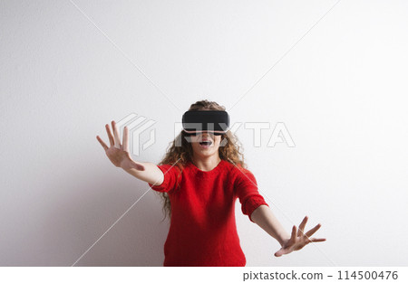 Young teenage girl with VR headset. Virutal reality, VR technology. Studio shot on white background with copy space. Young teenage girl with VR headset. Virutal reality, VR technology. Studio shot on white background with copy space. 114500476