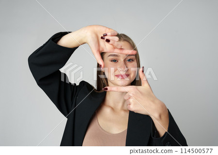 Woman Making a Camera Gesture With Her Fingers 114500577