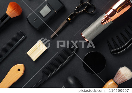 An Assortment of Professional Hairdressing Tools Laid Out on a Dark Surface An Assortment of Professional Hairdressing Tools Laid Out on a Dark Surface 114500907