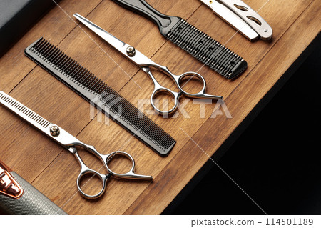 Professional Barber Tools Laid Out on Wooden Surface for Mens Grooming Session 114501189