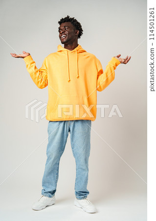 Man in Yellow Hoodie With Hands Out Man in Yellow Hoodie With Hands Out 114501261