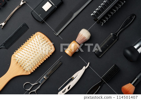 Variety of Hair Styling Tools and Accessories Displayed on a Dark Background Variety of Hair Styling Tools and Accessories Displayed on a Dark Background 114501407