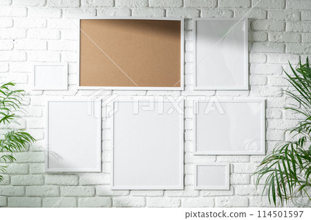 Varied Sized Photo Frames Displayed on a White Brick Wall Varied Sized Photo Frames Displayed on a White Brick Wall 114501597