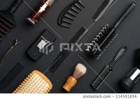 Variety of Hair Styling Tools and Accessories Displayed on a Dark Background 114501834