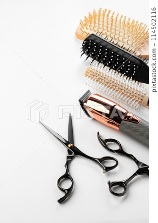 Black hairdressing tools and various hairbrushes on white background Black hairdressing tools and various hairbrushes on white background 114502116