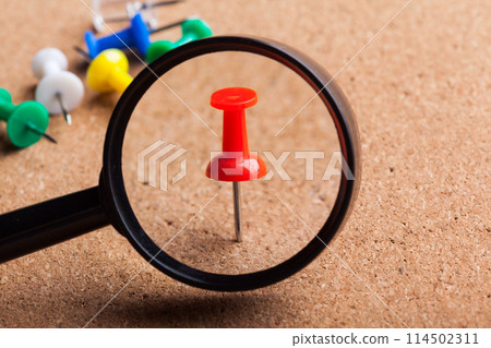 blank brown board and a magnifying glass 114502311