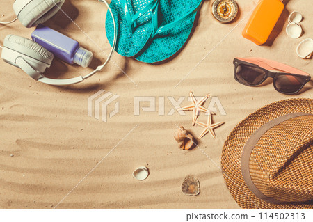shoes and hat on the beach 114502313