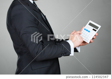 Accountant Businessman with calculator Accountant Businessman with calculator 114502347