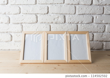 blank black picture frame on the wall 114502502