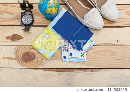 Accessories for travel. Passport, photo camera and travel map. Top view. Holidays and tourism concept Accessories for travel. Passport, photo camera and travel map. Top view. Holidays and tourism concept 114502639