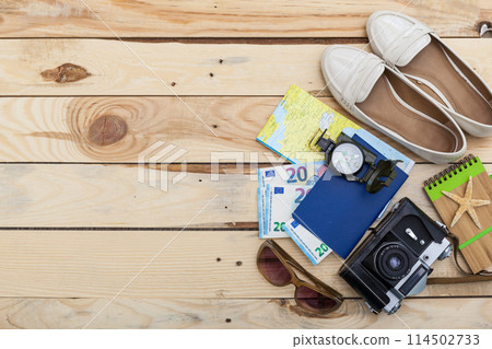 Accessories for travel. Passport, photo camera and travel map. Top view. Holidays and tourism concept Accessories for travel. Passport, photo camera and travel map. Top view. Holidays and tourism concept 114502733