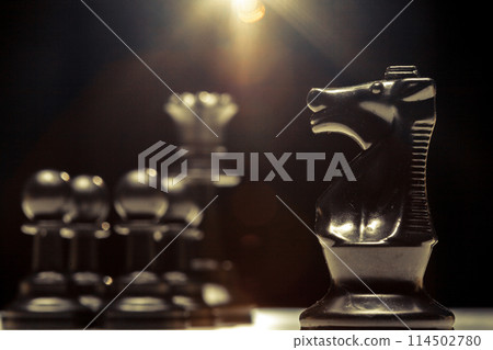 chess pieces on a black background chess pieces on a black background 114502780