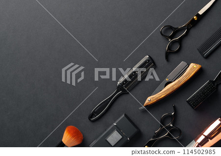 An Assortment of Professional Hairdressing Tools Laid Out on a Dark Surface An Assortment of Professional Hairdressing Tools Laid Out on a Dark Surface 114502985