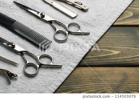 Hairdressing professional scissors on wooden background close up Hairdressing professional scissors on wooden background close up 114503079