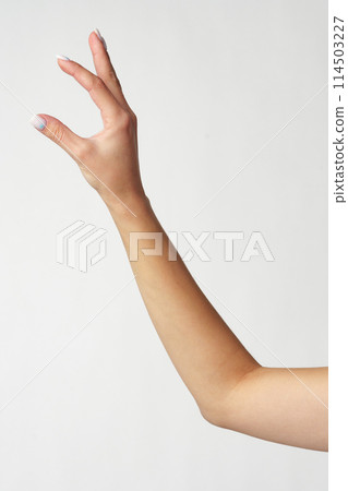 Hand picking something against white background copy space 114503227