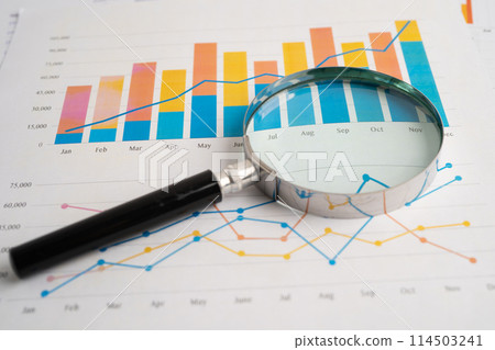 Magnifying glass on spreadsheet and graph paper. Financial development, Banking Account, Statistic, Investment Analytic research data economy, Business. Magnifying glass on spreadsheet and graph paper. Financial development, Banking Account, Statistic, Investment Analytic research data economy, Business. 114503241